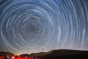 A star trail of the North Star, looking like a tunnel of concentric circles of light. 

The North Star image is a metaphor for setting direction for outcome-oriented, continuous transformation, everywhere.